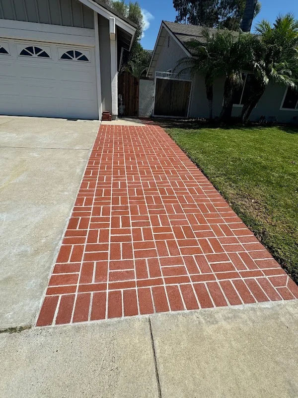 Red clay brick walkway in running bond pattern with white mortar joints leading to home entrance