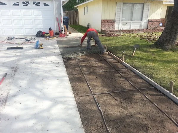 Concrete driveway installation with control joints and finished concrete surfaces