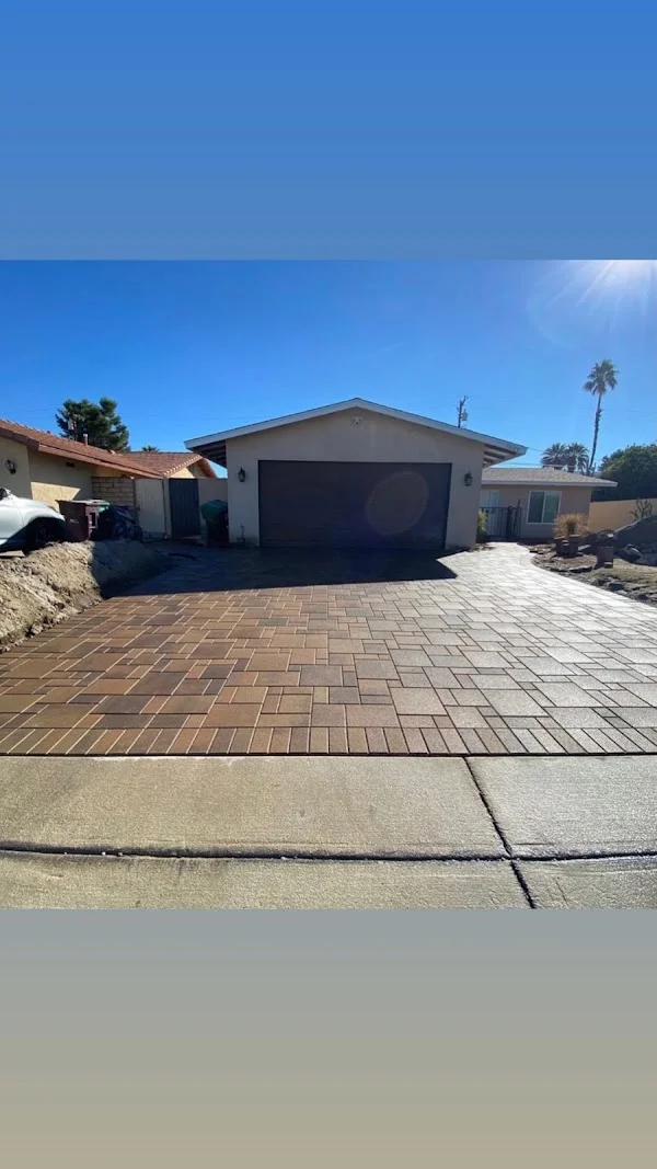 Clay brick paver driveway with running bond pattern in front of residential garage