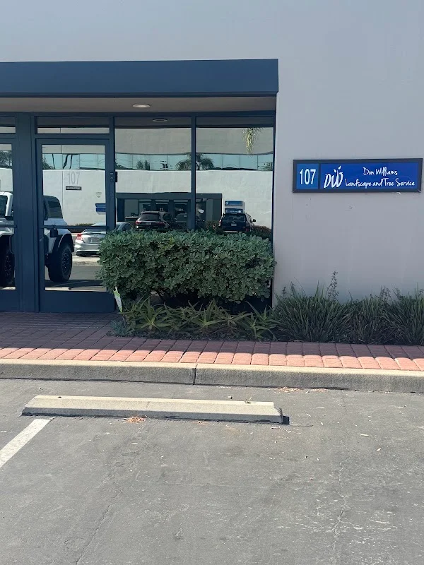Commercial storefront with installed shrubs and ornamental grasses along brick paver walkway